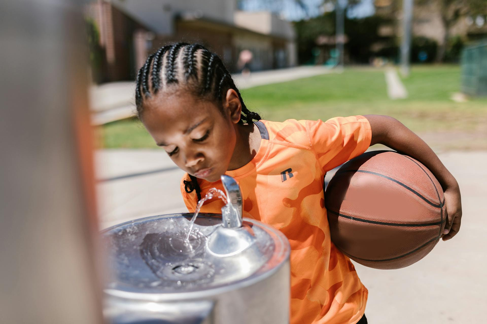 Boy drinking from a water fountain