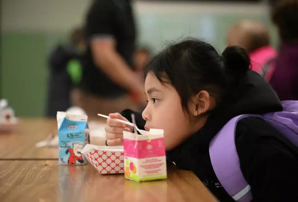 Students at Giffen Memorial Elementary School are fed breakfast in the school cafeteria on Wednesday in Albany. Will Waldron/Times Union