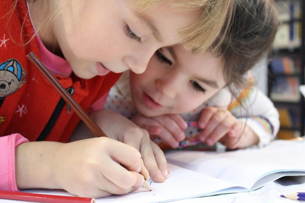 Children writing in a notebook